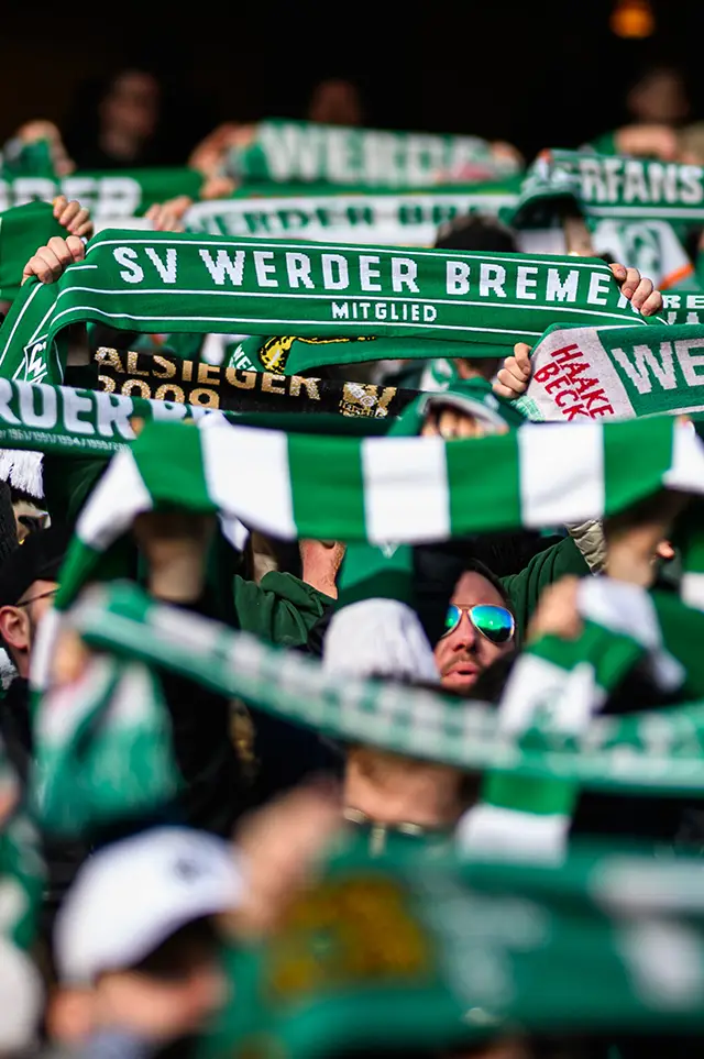 SV Werder Bremen fans holding up their team's scarves. (Photo)