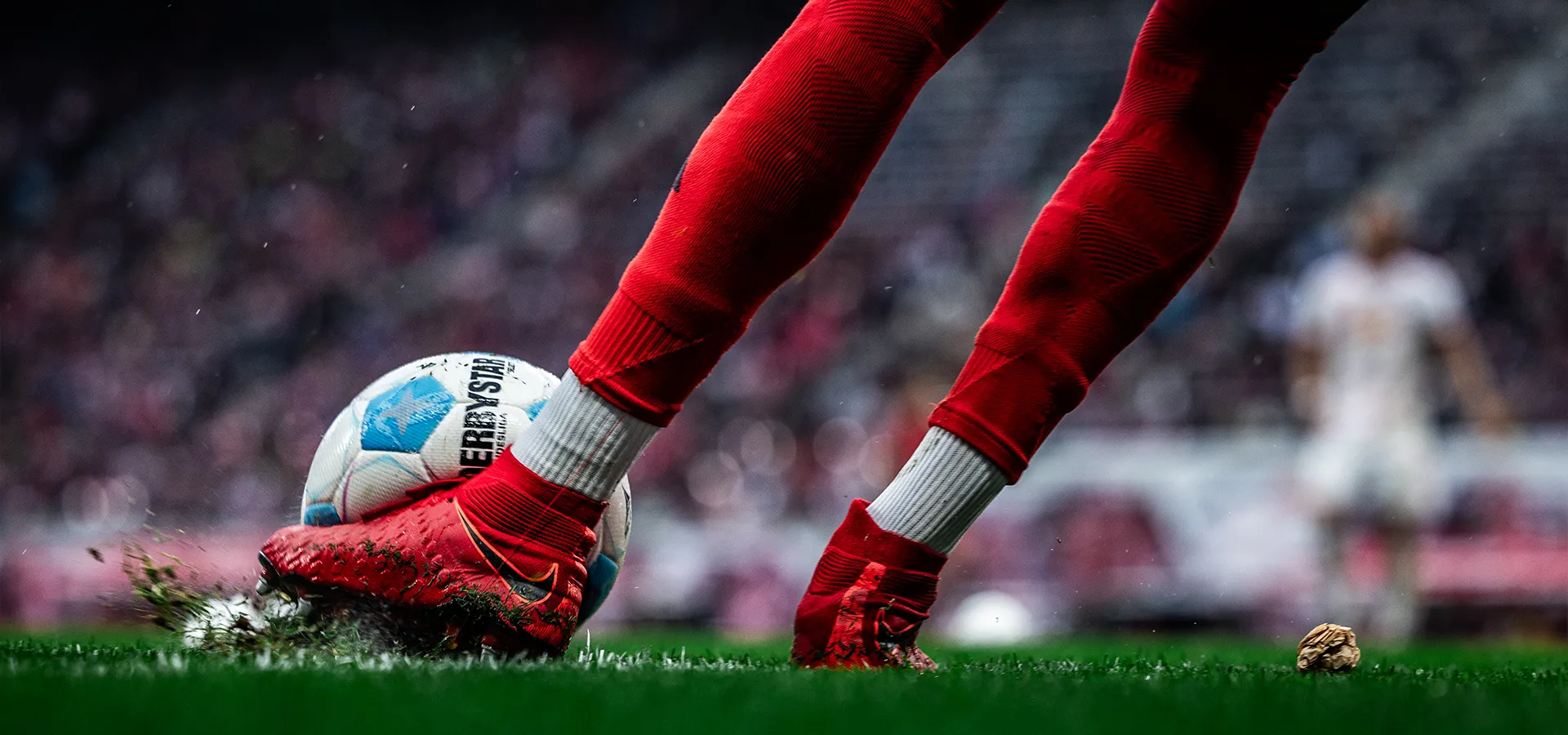Close-up of a ball game featuring a player wearing red shoes (Photo)